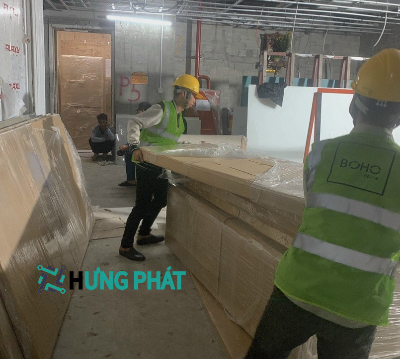 2 nhân công đang bốc xếp gỗ